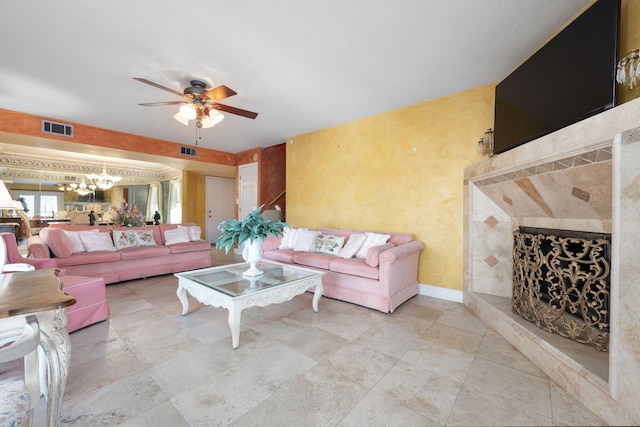 living room featuring ceiling fan with notable chandelier