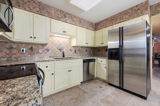 kitchen featuring sink, cream cabinets, and appliances with stainless steel finishes