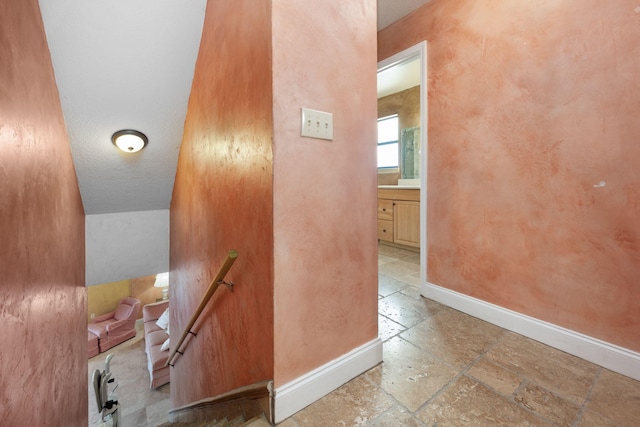 stairway featuring vaulted ceiling