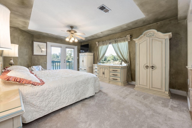 bedroom with access to exterior, ceiling fan, french doors, and light carpet