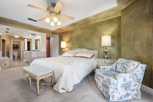 carpeted bedroom with ceiling fan and decorative columns