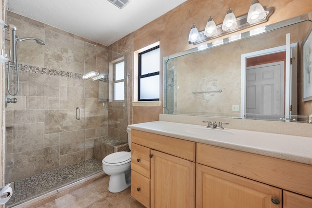 bathroom featuring vanity, toilet, and a shower with door