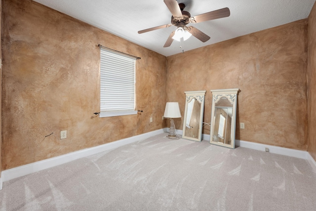 empty room with ceiling fan and light colored carpet