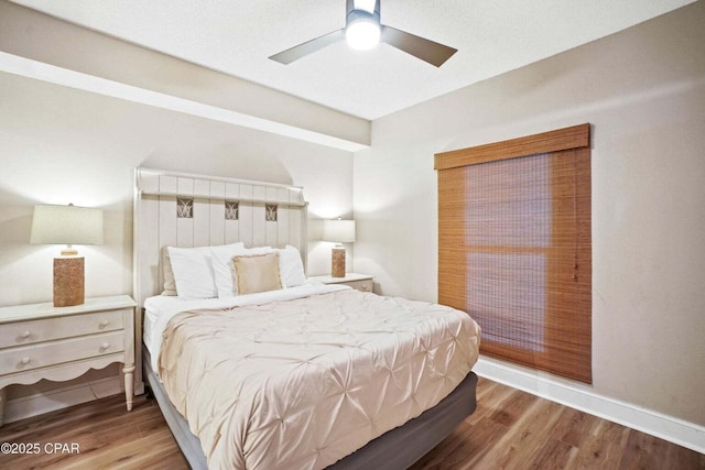 bedroom with hardwood / wood-style floors and ceiling fan