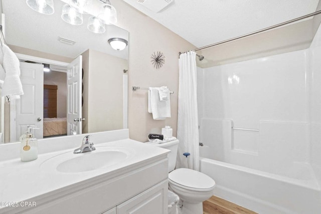 full bathroom with vanity, toilet, a textured ceiling, shower / tub combo with curtain, and wood-type flooring