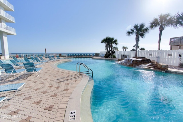 view of swimming pool with pool water feature and a patio area