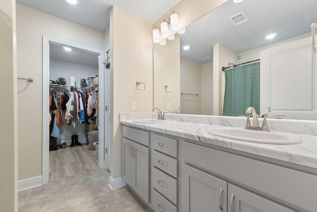 bathroom with vanity and walk in shower