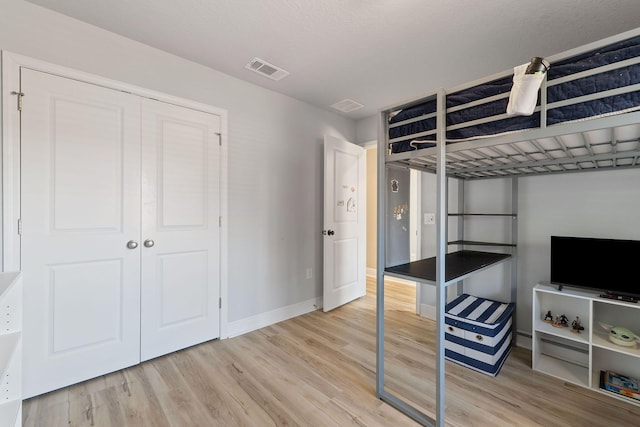 bedroom with a closet and hardwood / wood-style flooring