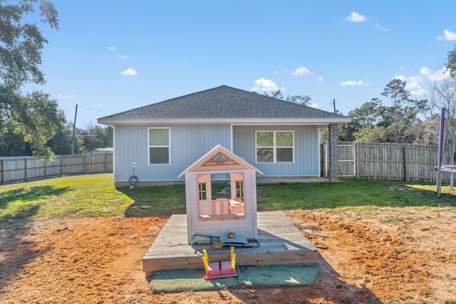 exterior space with a trampoline and a yard