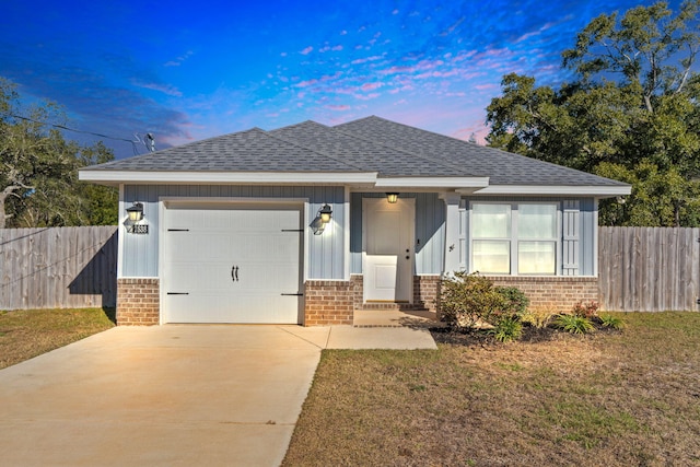 view of front of house with a garage and a lawn