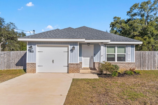 view of front of property featuring a front yard and a garage