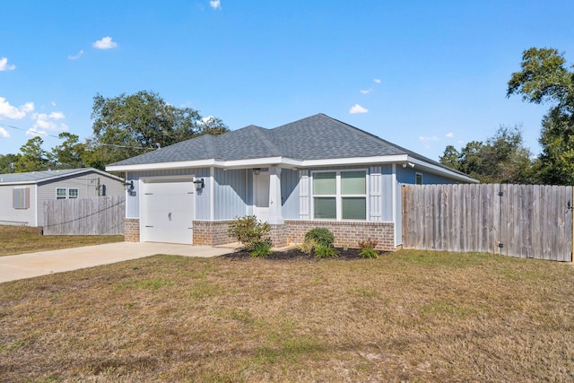 view of front of property featuring a garage and a front lawn