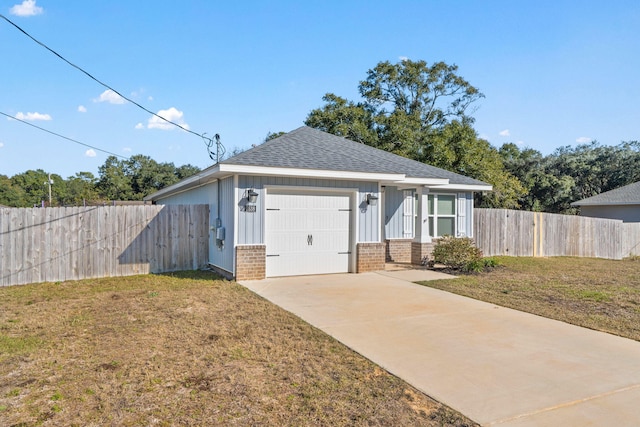 view of front of property with a garage and a front yard