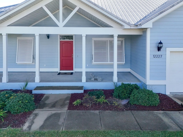 view of exterior entry with covered porch