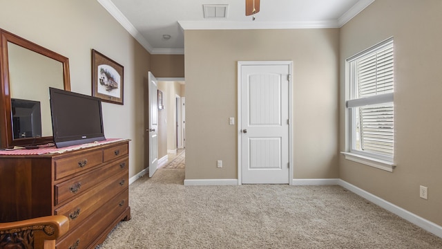 carpeted bedroom with ceiling fan and crown molding