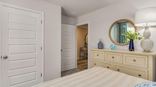 carpeted bedroom with a textured ceiling