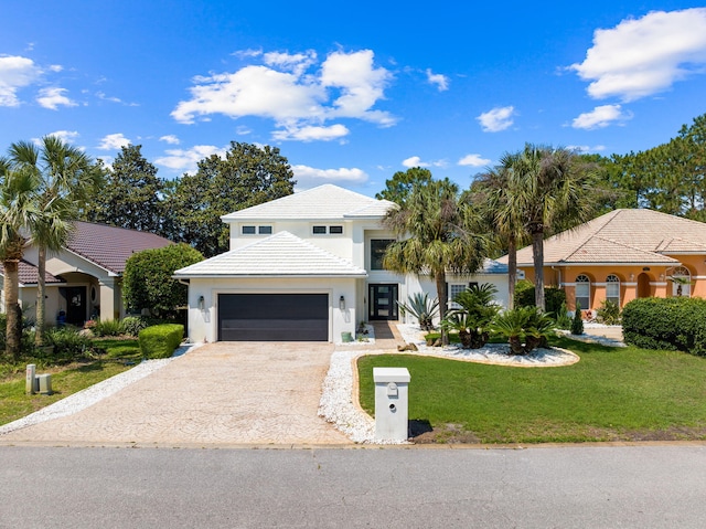 view of front facade featuring a garage and a front lawn