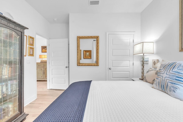 bedroom with light wood-type flooring and multiple windows