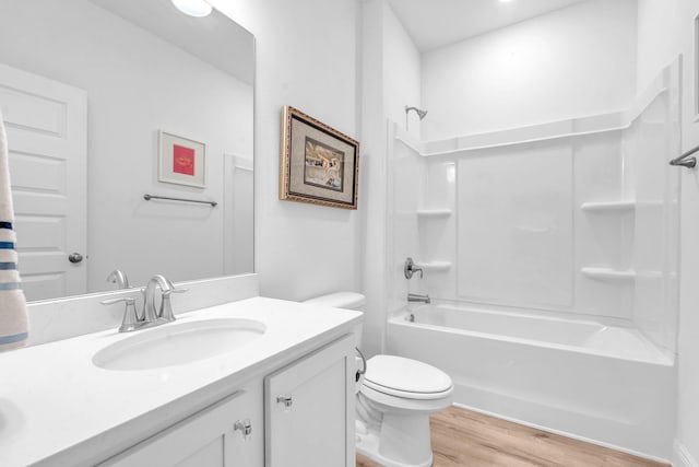 full bathroom featuring hardwood / wood-style floors, vanity,  shower combination, and toilet