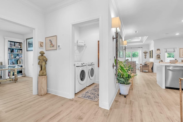 washroom with separate washer and dryer, light hardwood / wood-style flooring, and ornamental molding