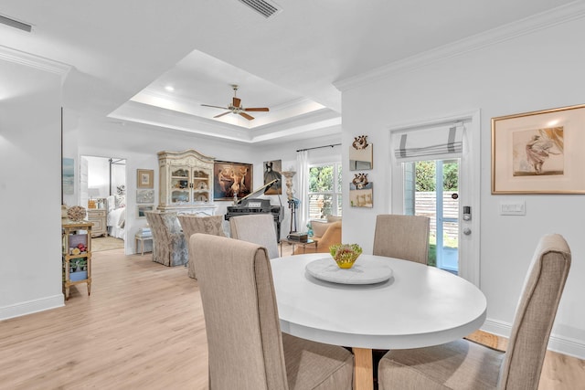 dining room with light hardwood / wood-style floors, ceiling fan, and crown molding