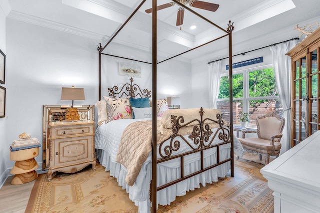 bedroom with ceiling fan, crown molding, and light hardwood / wood-style flooring