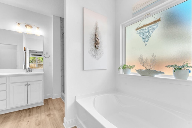 bathroom featuring wood-type flooring, vanity, and shower with separate bathtub