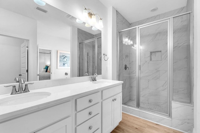 bathroom featuring a shower with door, vanity, and hardwood / wood-style flooring