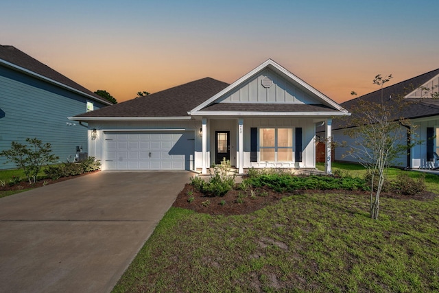 view of front facade with a garage and a lawn