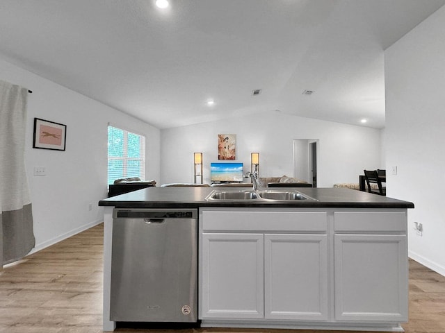 kitchen featuring stainless steel dishwasher, sink, white cabinets, lofted ceiling, and an island with sink