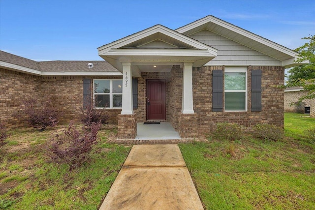 doorway to property with a yard