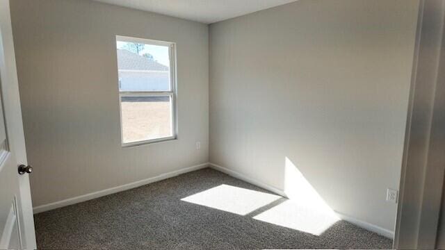 empty room featuring dark carpet