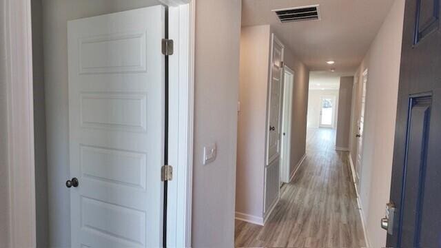 hallway with light wood-type flooring