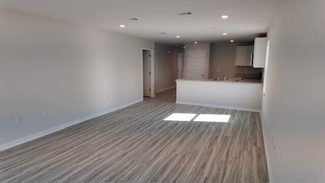 unfurnished living room with light wood-type flooring