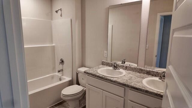 full bathroom featuring toilet, vanity, and tub / shower combination