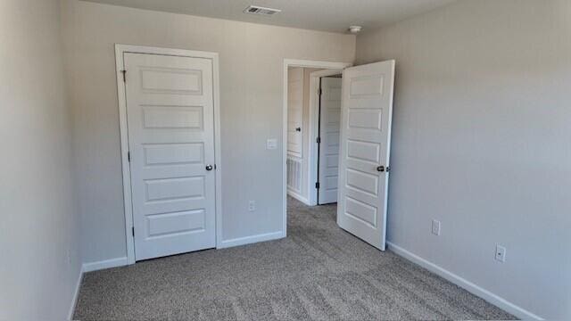 unfurnished bedroom featuring light colored carpet