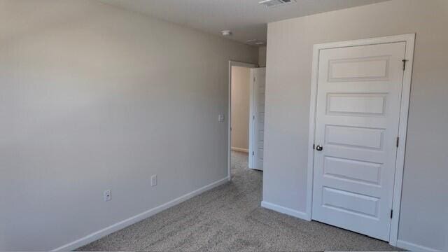 unfurnished bedroom featuring light colored carpet