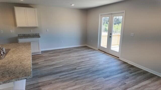 unfurnished dining area with french doors and dark hardwood / wood-style floors