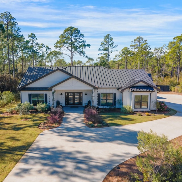 view of front of home featuring a front yard and french doors