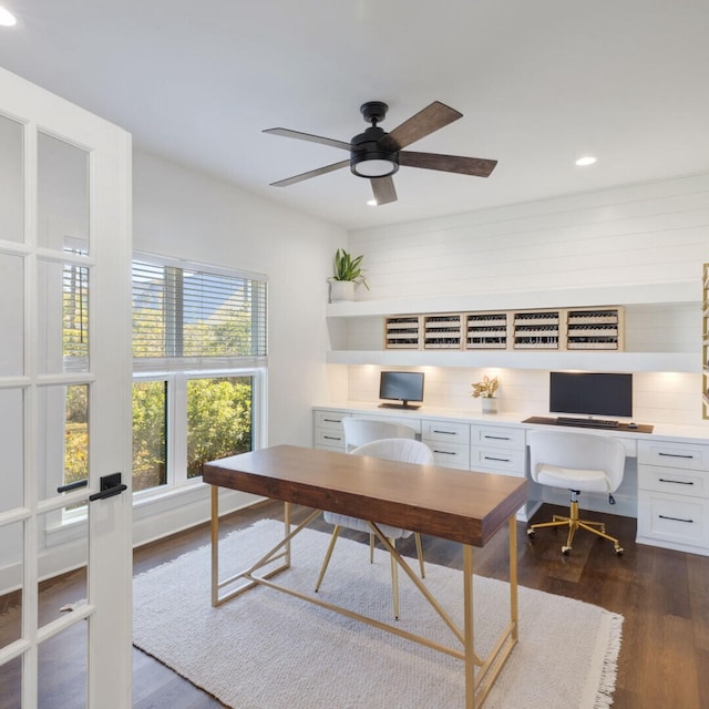 office with ceiling fan and dark wood-type flooring