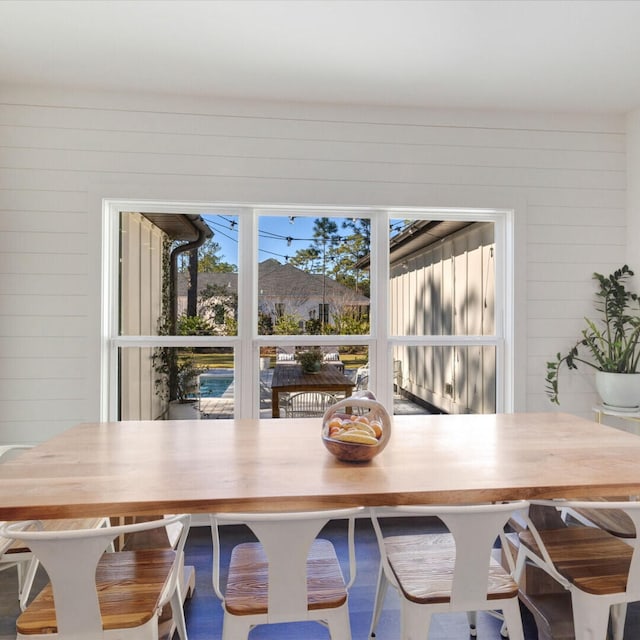 dining room with wood walls