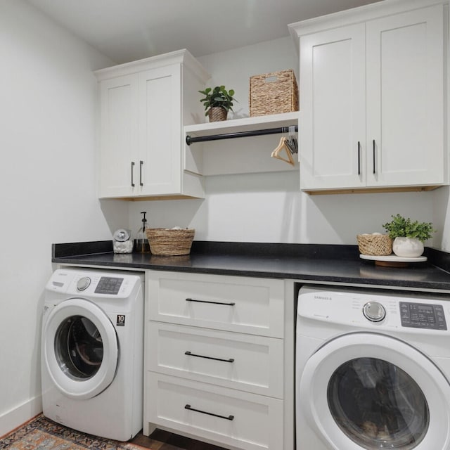 clothes washing area with cabinets and washing machine and dryer