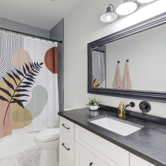 bathroom featuring tile patterned floors, vanity, and toilet