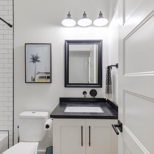 full bathroom with vanity, toilet, and tiled shower / bath combo