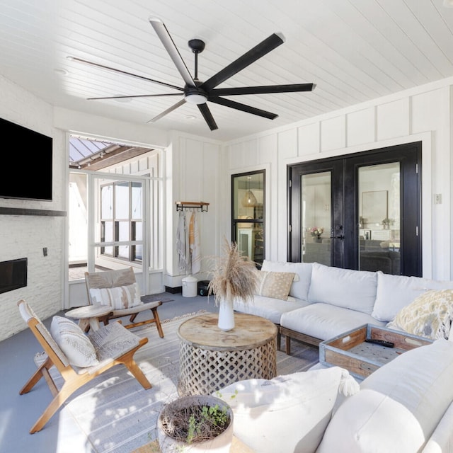 living room featuring ceiling fan, french doors, and wood-type flooring