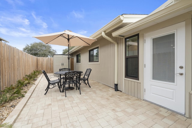 view of patio with a storage shed