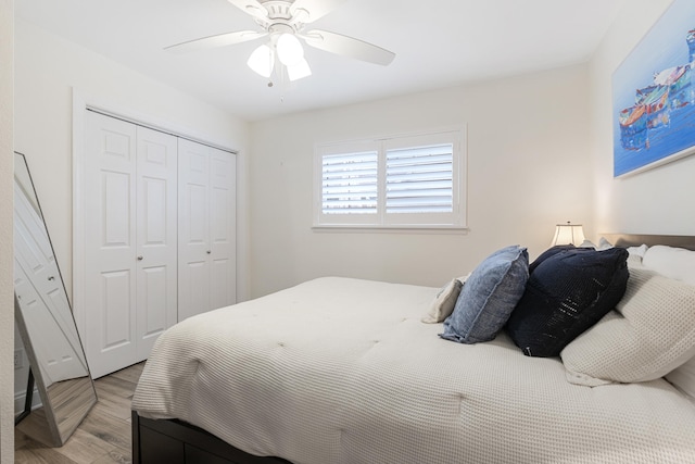 bedroom with light hardwood / wood-style flooring, a closet, and ceiling fan