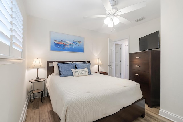 bedroom with ceiling fan and light wood-type flooring