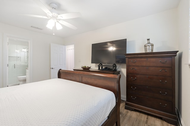 bedroom with wood-type flooring, ceiling fan, and ensuite bathroom