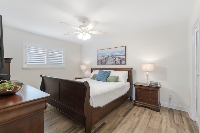 bedroom with ceiling fan and light wood-type flooring